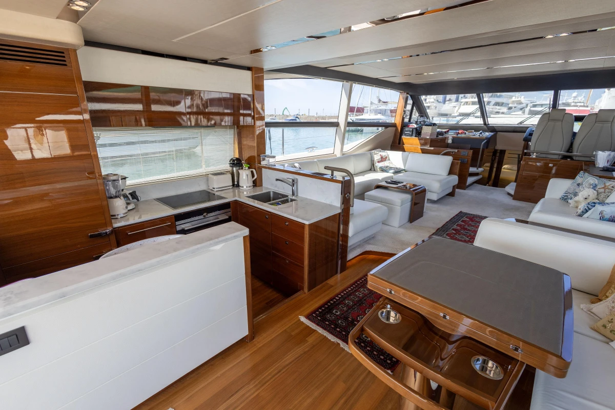 Luxurious 2017 Princess 68 yacht interior with modern kitchen and elegant seating area.