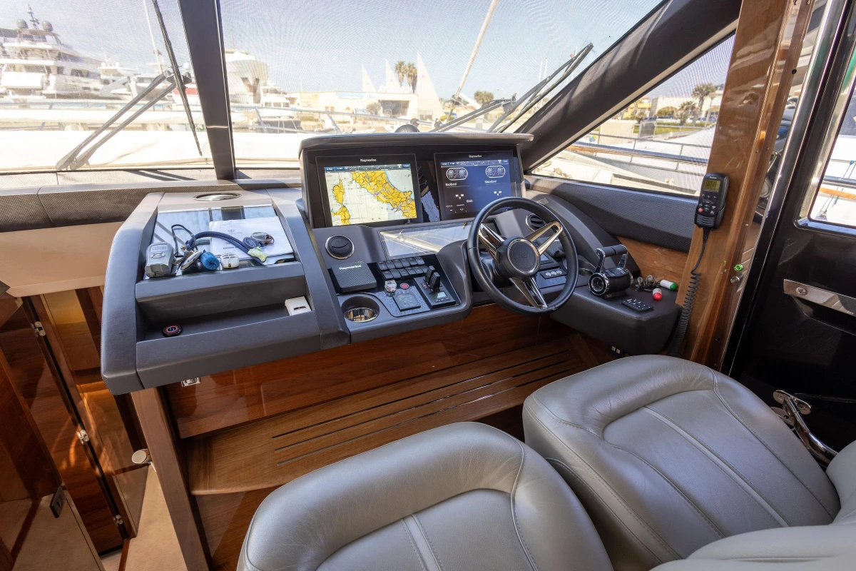 Luxurious 2017 Princess 68 yacht cockpit with modern navigation system and leather seating.