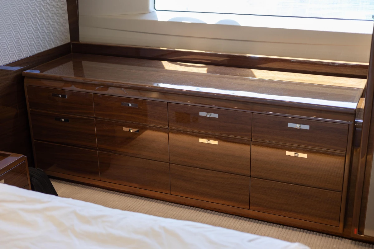 Luxurious wooden dresser in a 2017 Princess 68 yacht interior.