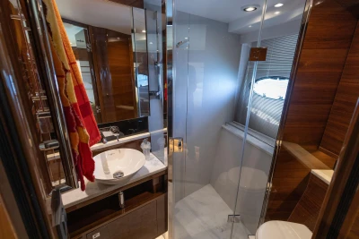 Luxurious bathroom in 2017 Princess 68 yacht with modern fixtures and elegant wood finishes.