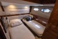 Luxurious cabin interior of 2017 Princess 68 yacht with twin beds and elegant wood finish.
