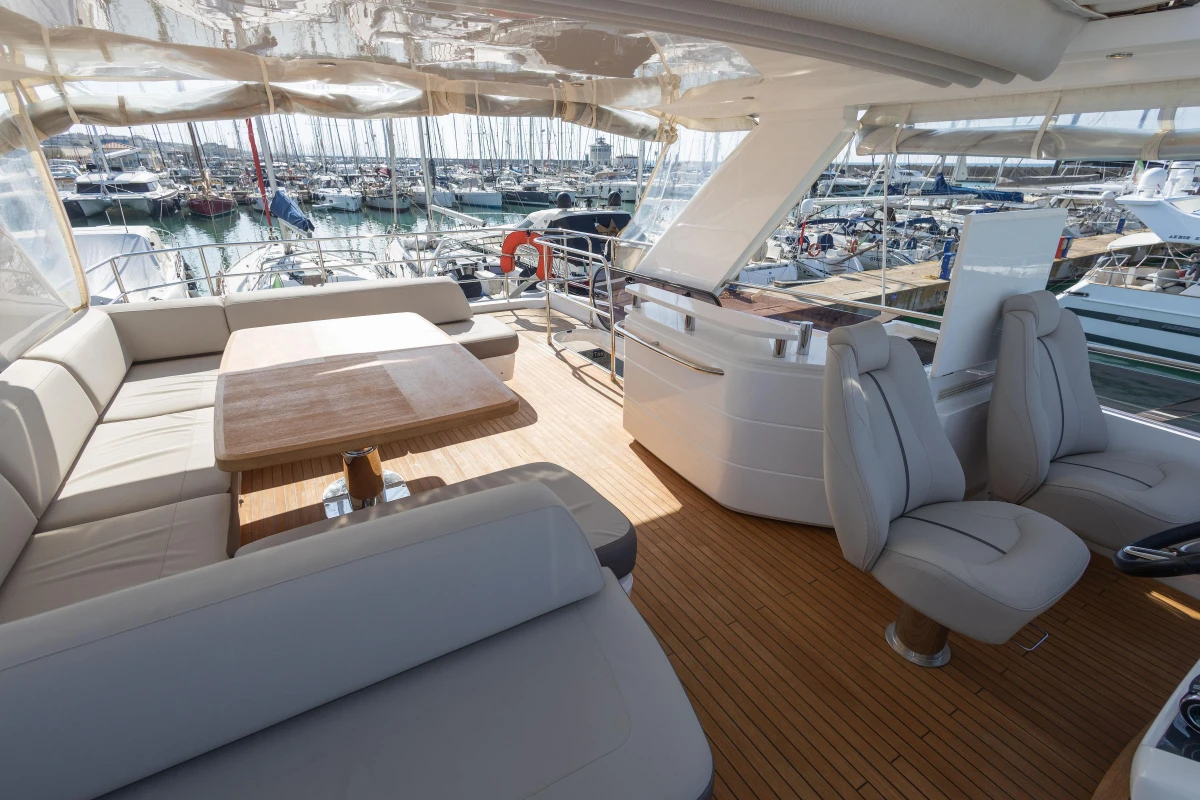 Luxurious 2017 Princess 68 yacht interior with elegant seating and wooden deck.