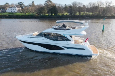 Luxury yacht Princess F50 2025 on a calm river.