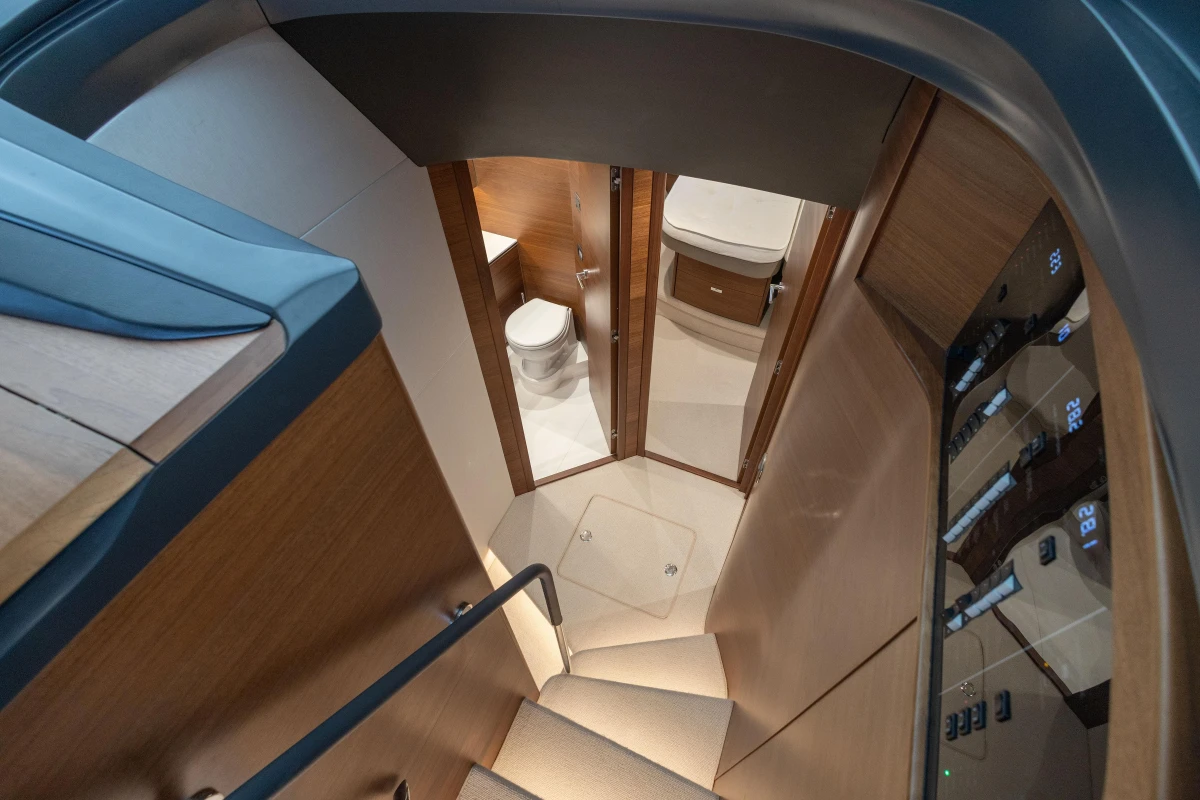Interior view of 2022 Princess V55 yacht, featuring a staircase and modern bathroom.
