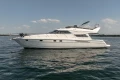1995 Princess 60 yacht cruising on calm waters under a clear sky.
