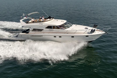 1995 Princess 60 yacht cruising on open water, showcasing sleek design and powerful performance.