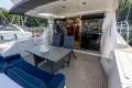Luxurious 1995 Princess 60 yacht deck with seating, table, and marina view.