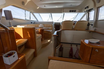 Luxurious interior of a 1995 Princess 60 yacht with elegant seating and helm.