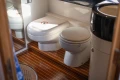 Bathroom interior of a 1995 Princess 60 yacht with wooden flooring.