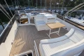 Luxurious 1995 Princess 60 yacht deck with seating and table, docked at marina.