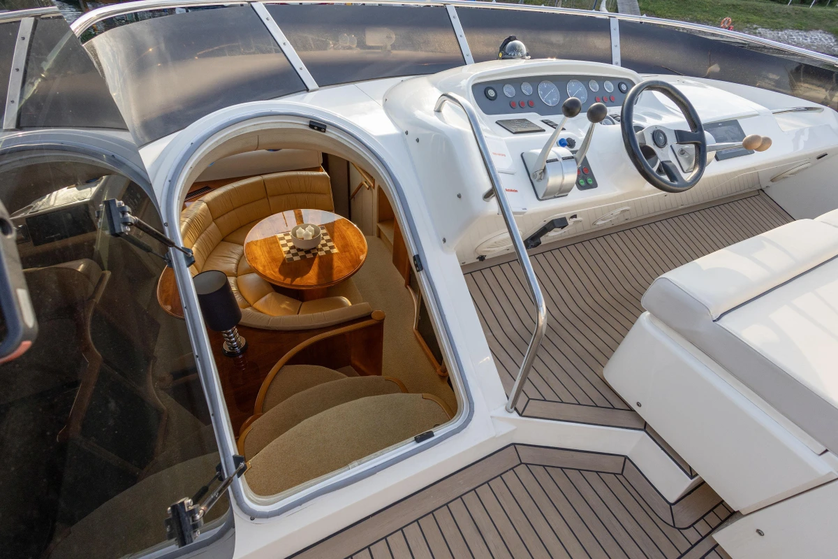 Luxurious 1995 Princess 60 yacht interior with elegant seating and modern helm controls.