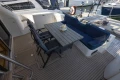 Outdoor seating area on a 1995 Princess 60 yacht with table and cushioned seats.