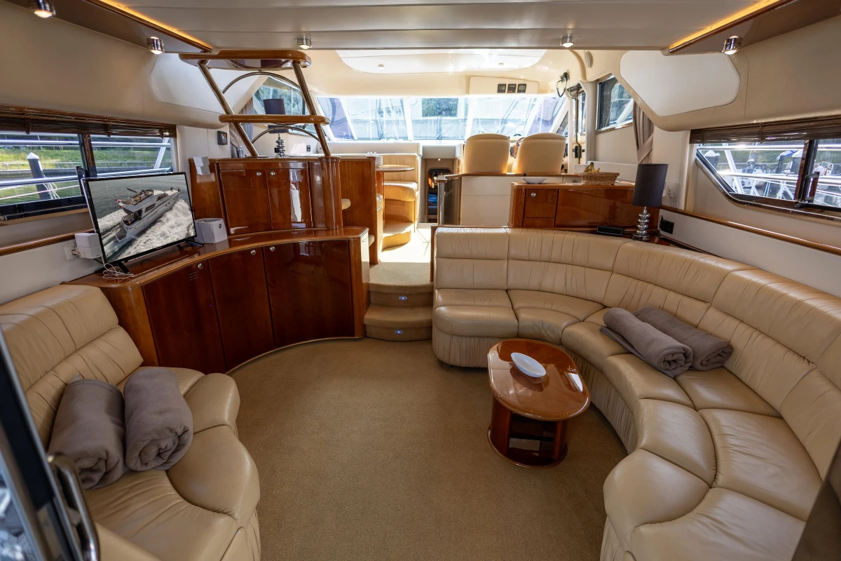 Luxurious 1995 Princess 60 yacht interior with plush seating and elegant wood finishes.