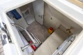 Interior cabin of a 1995 Princess 60 yacht, featuring a compact bathroom and storage area.