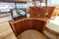 Luxurious interior of a 1995 Princess 60 yacht with wooden cabinetry and a mounted TV.