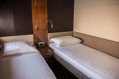 Interior of 2013 Princess 72 Motor Yacht with twin beds and modern decor.