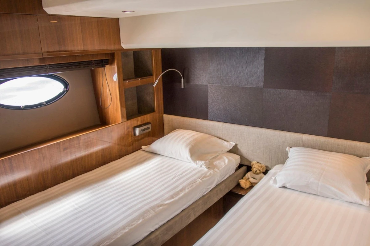 Luxurious twin bedroom in 2013 Princess 72 Motor Yacht with elegant wood paneling.