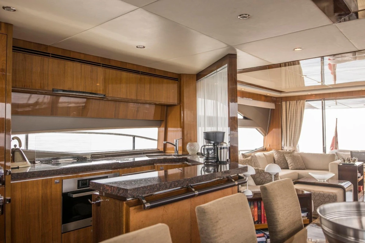 Luxurious interior of 2013 Princess 72 Motor Yacht with modern kitchen and elegant seating area.