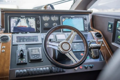 Control panel of 2013 Princess 72 Motor Yacht with steering wheel and navigation displays.