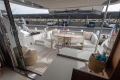 Luxurious 2020 Princess F62 yacht deck with seating and table, docked at marina.