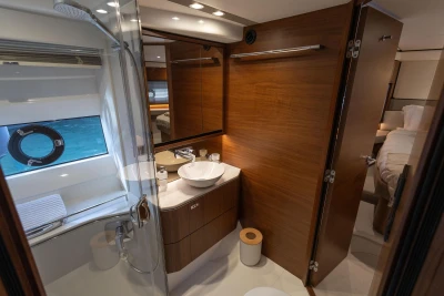 Luxurious bathroom interior of 2020 Princess F62 yacht with modern fixtures and wooden accents.