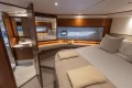 Luxurious cabin interior of 2020 Princess F62 yacht with elegant wood finishes.
