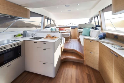 Luxurious interior of 2023 Princess F45 yacht with modern kitchen and seating area.