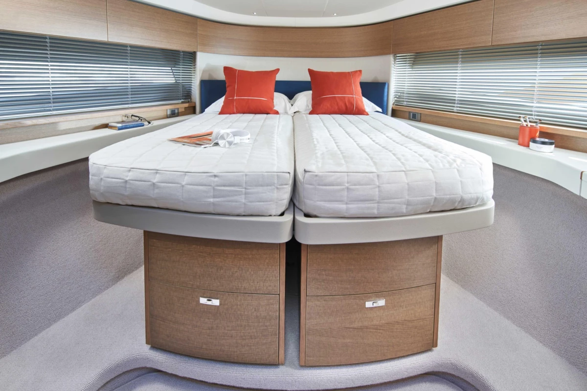Luxurious 2023 Princess F45 yacht cabin with twin beds and modern decor.