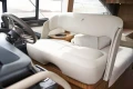 Luxurious interior of 2023 Princess F45 yacht with plush seating and modern steering wheel.