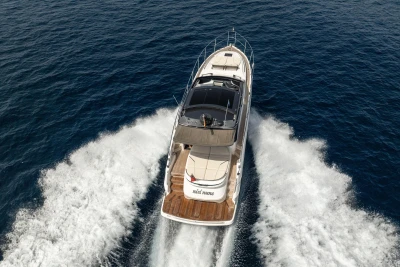 2023 Princess V50 Open yacht cruising on open sea, aerial view.