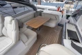 Luxurious 2023 Princess V50 Open yacht interior with elegant seating and wooden table.