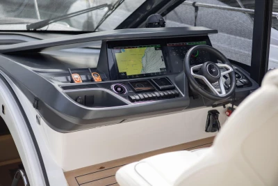 2023 Princess V50 Open yacht helm with advanced navigation system and sleek steering wheel.