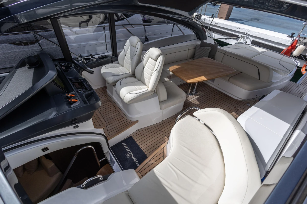 Luxurious interior of 2023 Princess V50 Open yacht with elegant seating and wooden flooring.