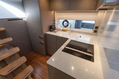 Modern kitchen interior of 2023 Princess V50 Open yacht, featuring sleek design and appliances.