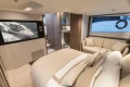 Luxurious interior of 2023 Princess V50 Open yacht with cozy bedroom and modern amenities.