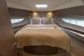 Luxurious bedroom interior of 2023 Princess V50 Open yacht with elegant bedding.