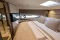 Luxurious bedroom interior of 2023 Princess V50 Open yacht with elegant bedding and modern design.