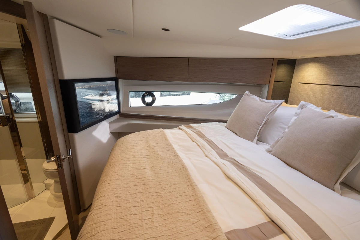 Luxurious bedroom interior of 2023 Princess V50 Open yacht with elegant bedding and modern design.