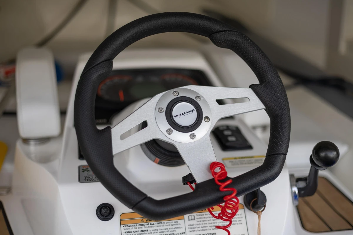Steering wheel of 2023 Princess V50 Open yacht, featuring modern controls and design.