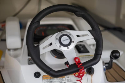 Steering wheel of 2023 Princess V50 Open yacht, featuring modern controls and design.