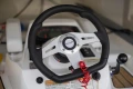Steering wheel of 2023 Princess V50 Open yacht, featuring modern controls and design.