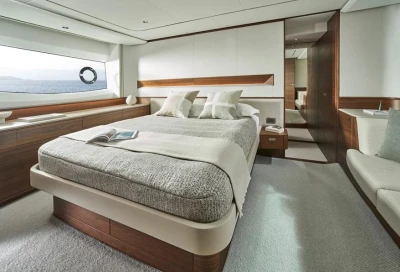 Luxurious bedroom interior of 2025 Princess F65 yacht with elegant design and sea view.