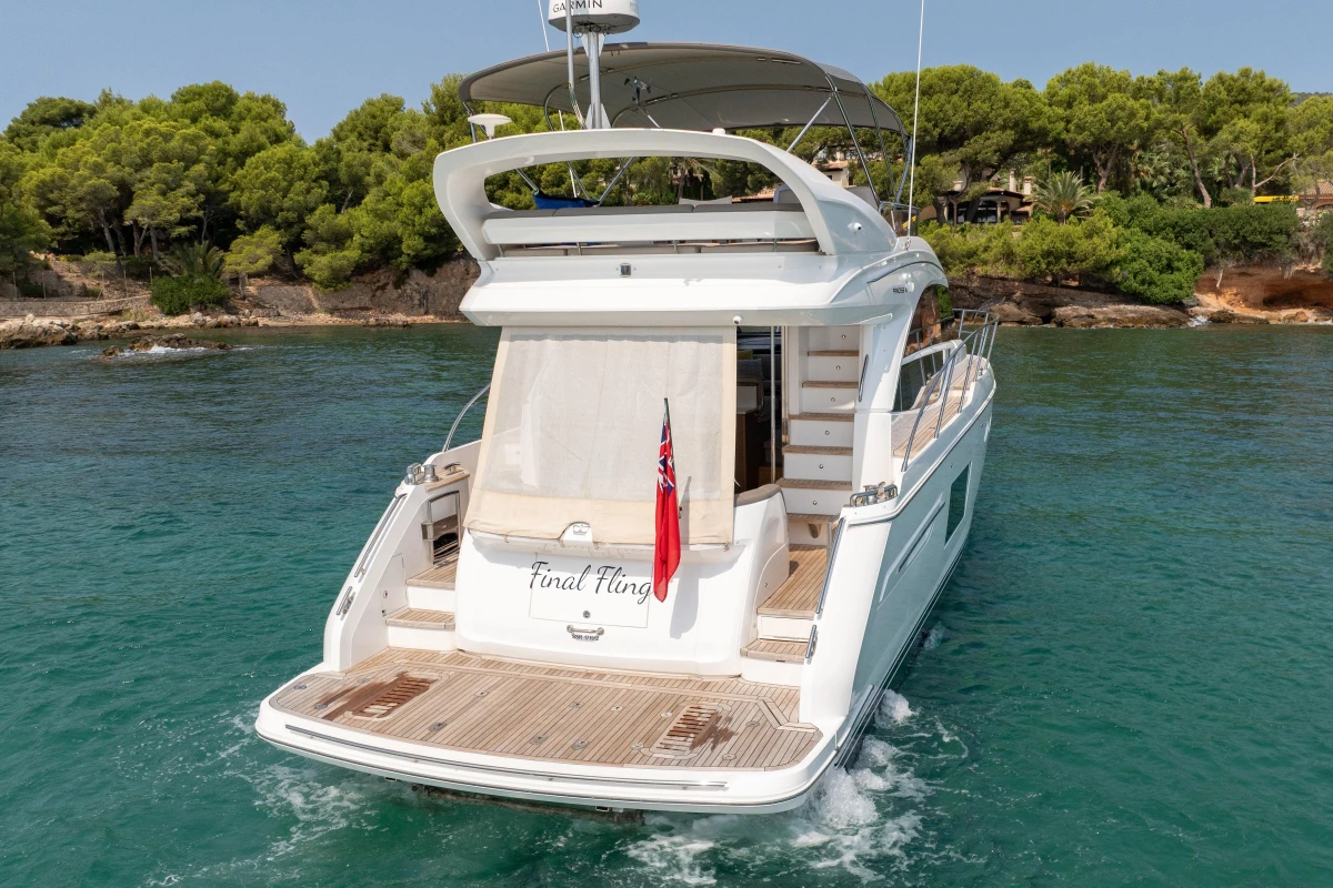 2018 Princess 49 yacht on serene water, surrounded by lush greenery.