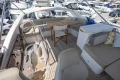 Luxurious 2018 Princess 49 yacht deck with seating, table, and marina view.
