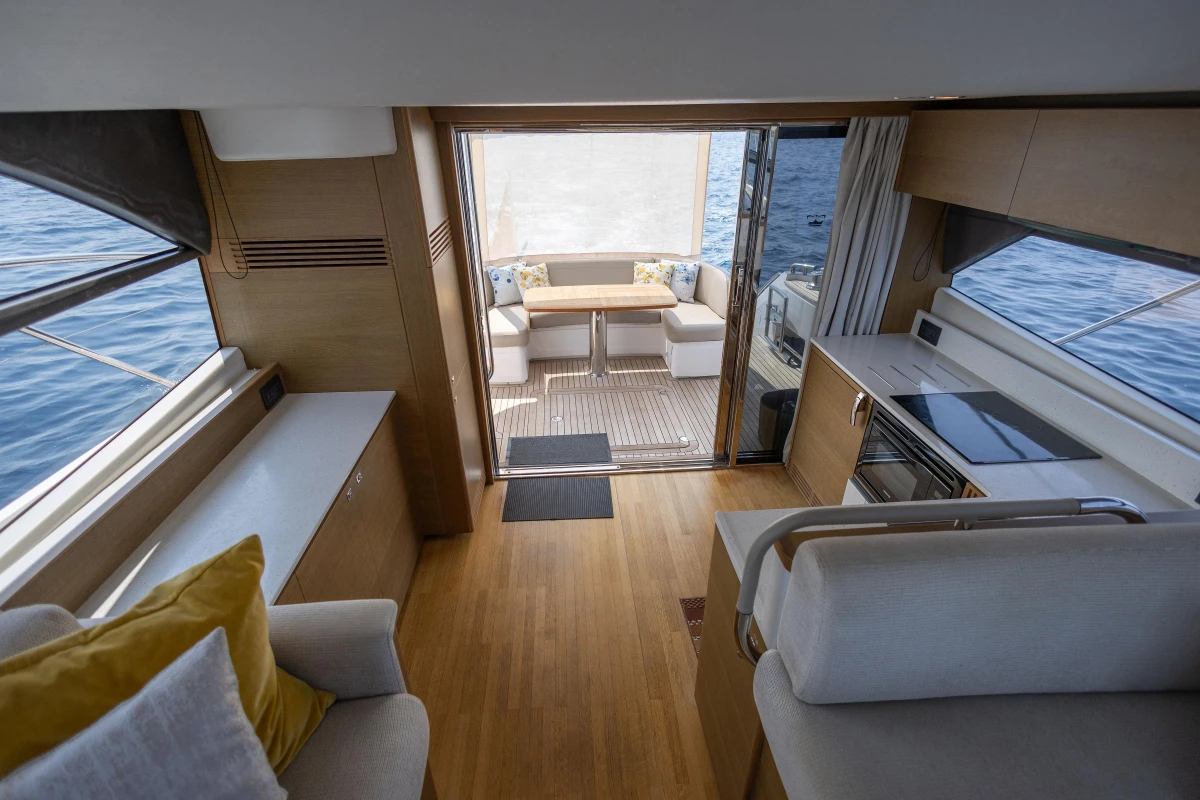 Luxurious interior of 2018 Princess 49 yacht with modern kitchen and seating area.