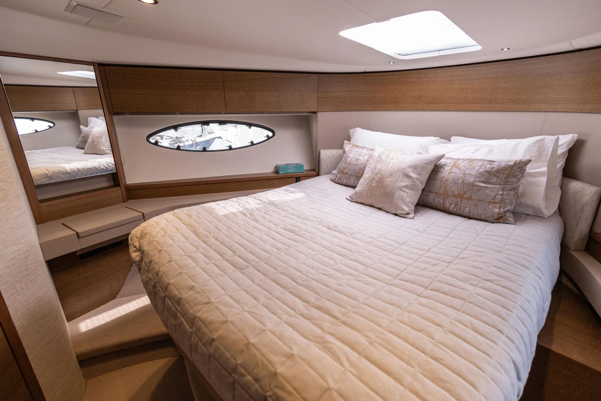 Luxurious cabin interior of 2018 Princess 49 yacht with elegant bedding and modern design.