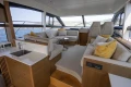 Luxurious interior of 2018 Princess 49 yacht with elegant seating and panoramic windows.