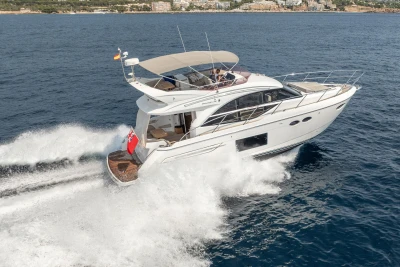 2018 Princess 49 yacht cruising on open sea, creating waves.