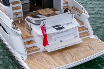 Luxury 2025 Princess F58 yacht with elegant teak deck and seating area.