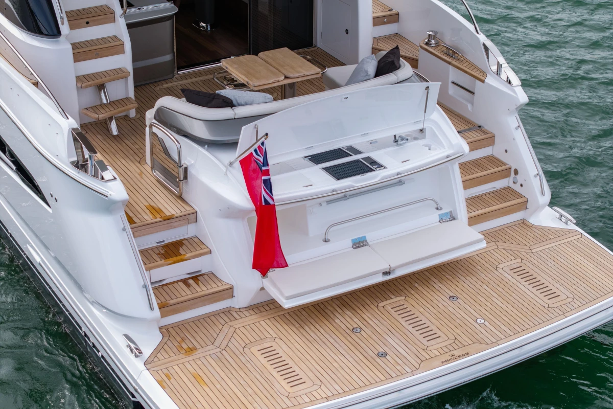Luxury 2025 Princess F58 yacht with elegant teak deck and seating area.